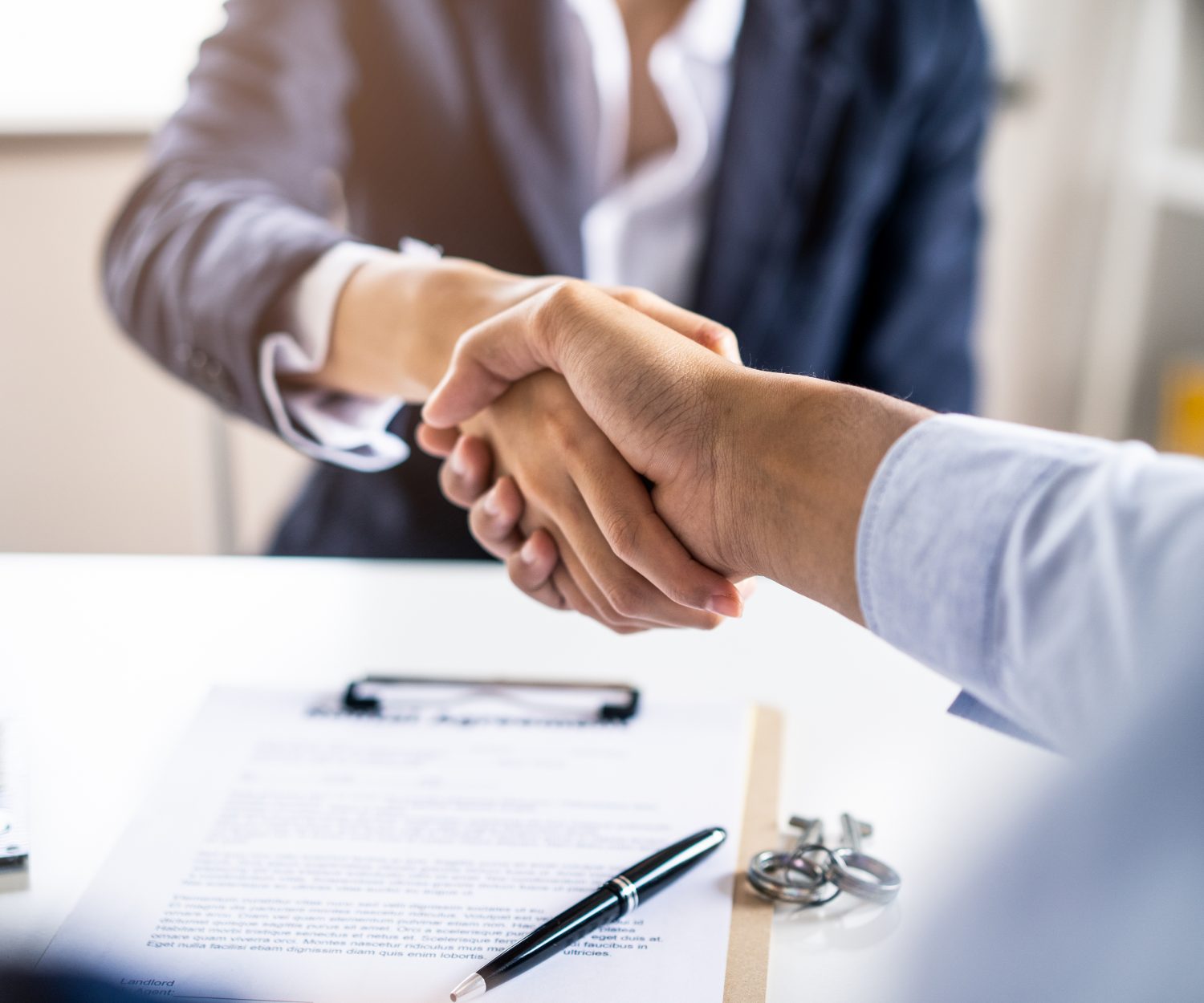 Successful handshake of man customer and house agency. Couple making sign contract then shaking hand with agent in office of property company. Feeling glad for success corporation. partnership concept