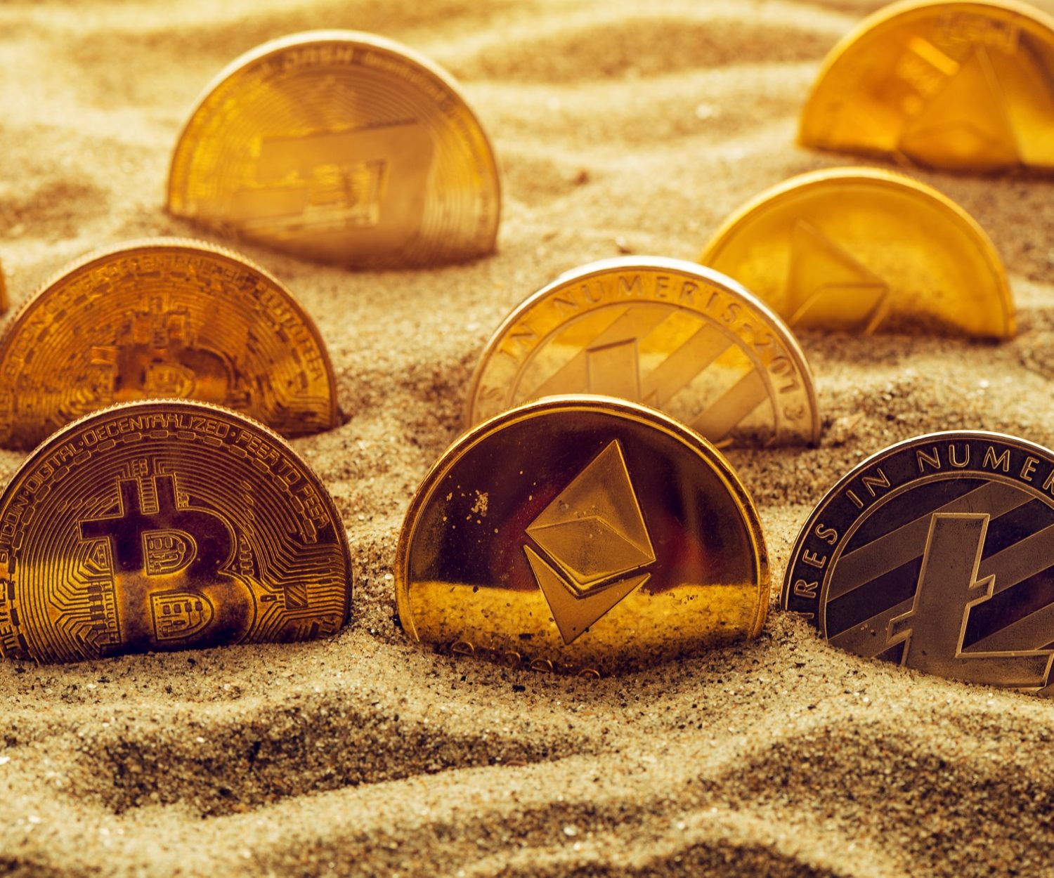 cryptocurrency-coins-in-sand-2021-08-26-